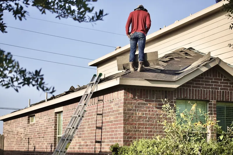 Professional roofer working on a residential roof in West Newport Beach